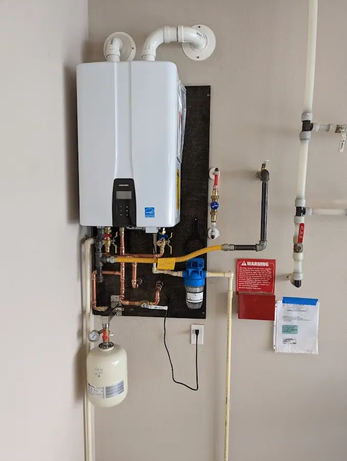 Professional plumber installing copper piping in a Pembroke home